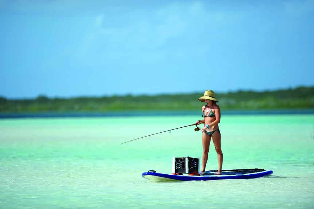 Woman fishing on a Stand Up Paddle Board, SUP Fishing, Symbol for review of the best SUP fishing boards, "SUPfishing" by bpkfishinglodge is licensed under CC BY 2.0