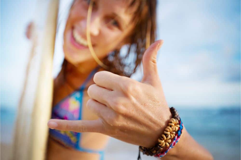 woman surfer wearing bracelets