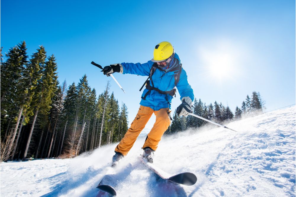 skier skiing in the mountains on fresh powder snow with a pair of All-Mountain skis