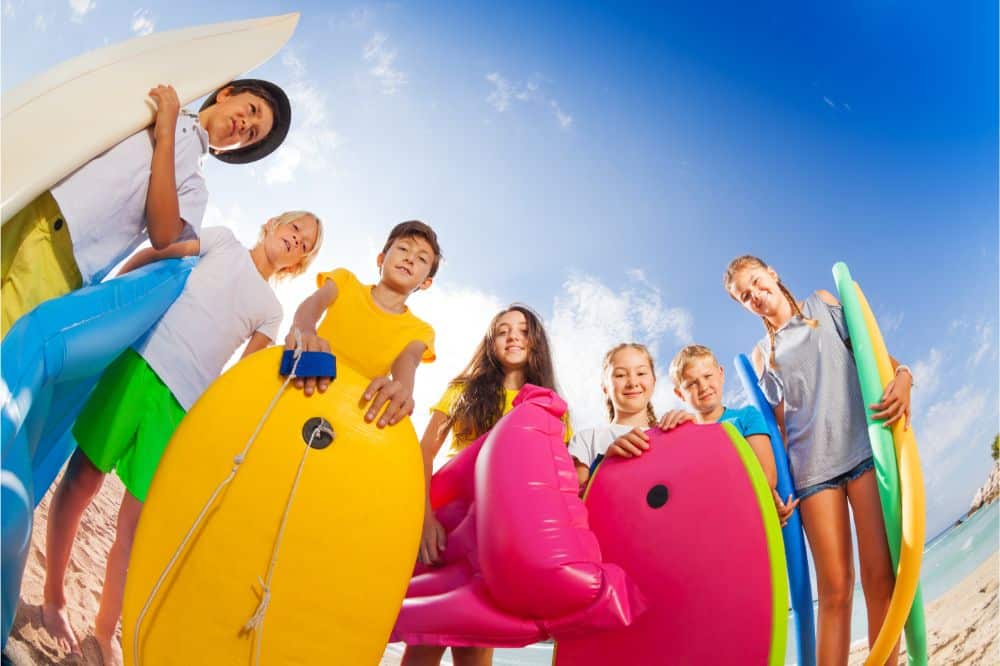 kids on beach with swimming stuff