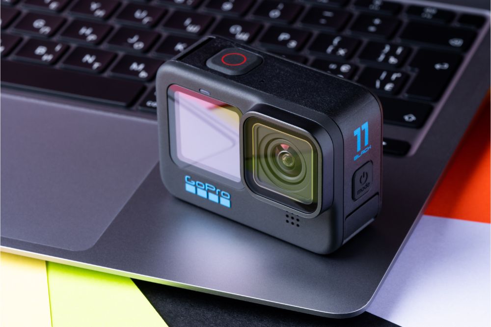 GoPro HERO 11 Black action camera on top of a laptop to compare the GoPro HERO 11 vs. GoPro HERO 10, 