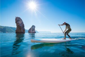 Young Man Having Fun Stand Up Paddling in the sea.