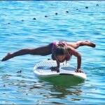 Woman doing Fitness on a Stand Up Paddle Board, SUP Freestyle by Karma Surf Retreat