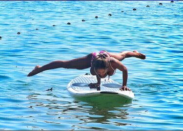 Woman doing Fitness on a Stand Up Paddle Board, SUP Freestyle by Karma Surf Retreat