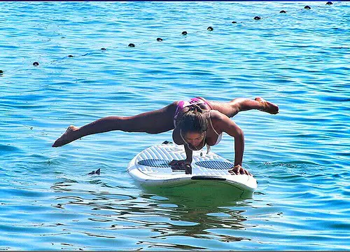 Woman doing Fitness on a Stand Up Paddle Board, SUP Freestyle by Karma Surf Retreat