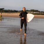 surfer man with surfboard running