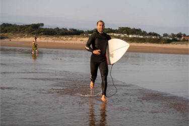 surfer man with surfboard running