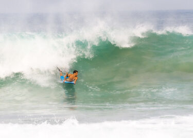 Bodyboarder riding a huge wave, Boogie Boarding in a big wave