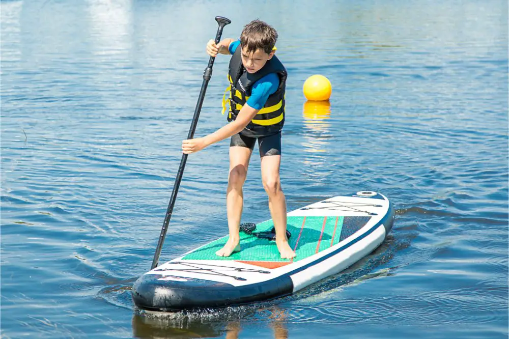 d Boy rowing on a standing Board.