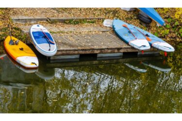 sup boards for swimming on the pier on the river Bank