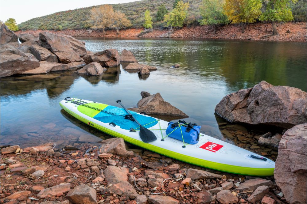 inflatable stand up paddleboard on mountain lake