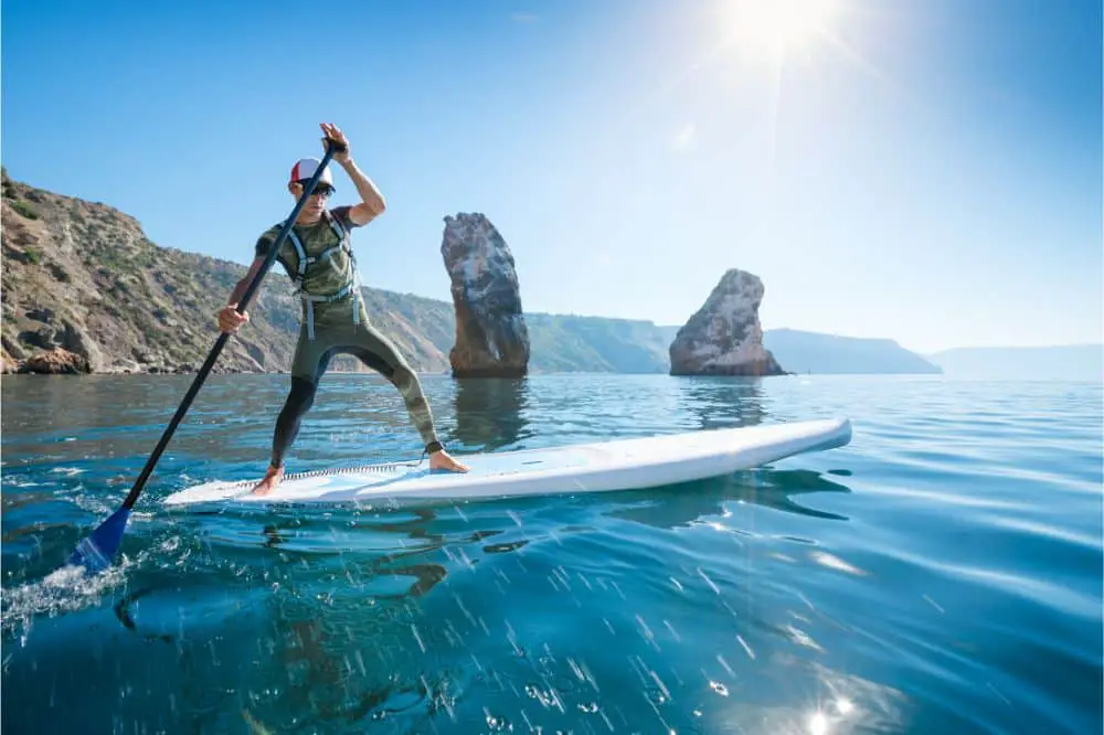 Young man floating on a SUP board