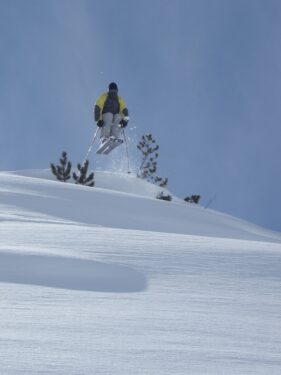Skier jumping in powder snow, powder skiing jump, photo by coolwatersports