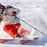 skier in a bright suit and outfit with long pigtails on her head