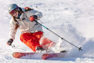 skier in a bright suit and outfit with long pigtails on her head