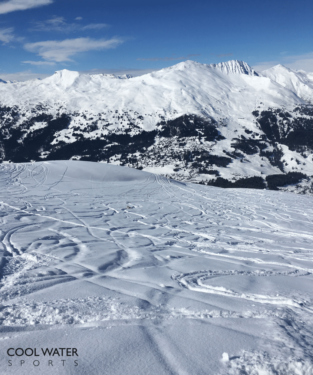 Picutre of a snowy valley with a nice powder run for skiing taken in the early afternoon used in an article discussing the best time to ski and when to go skiing