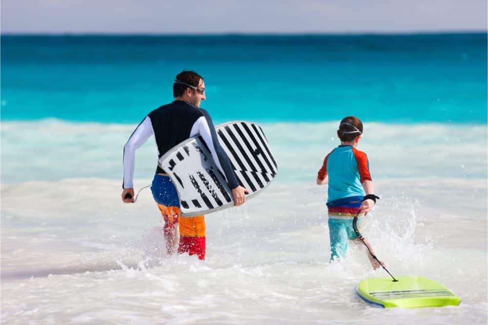 Father and son body boarding used in an article explaing how to start bodyboarding with kids