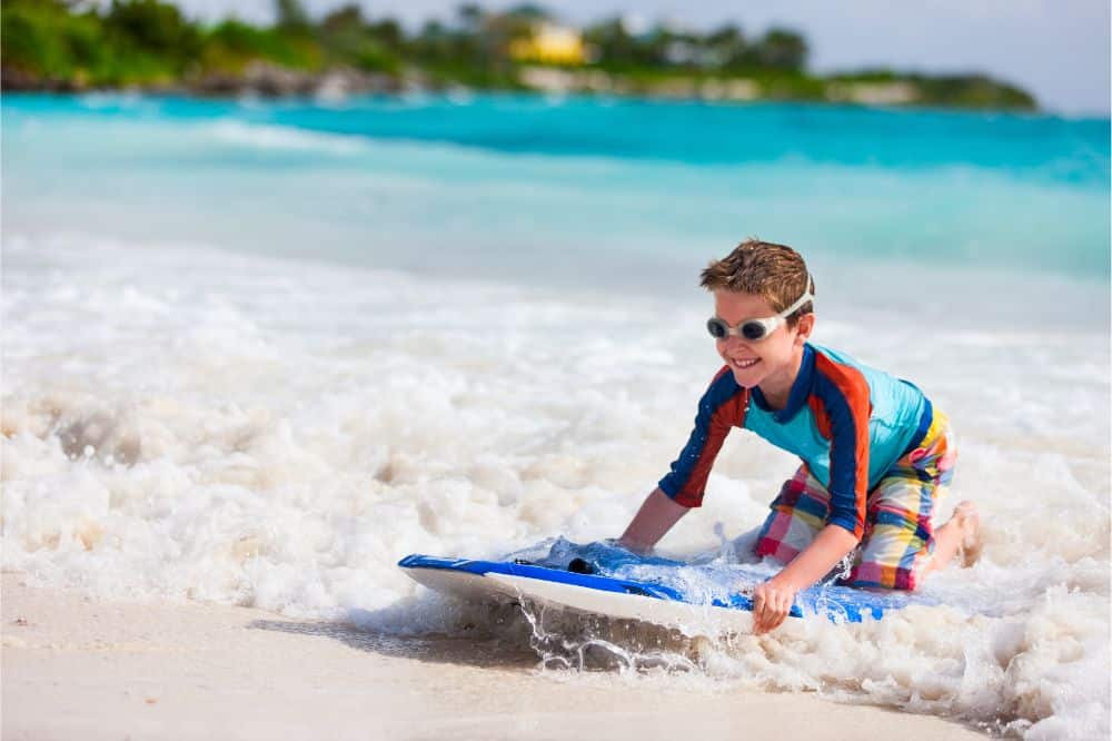 Boy swimming on boogie board