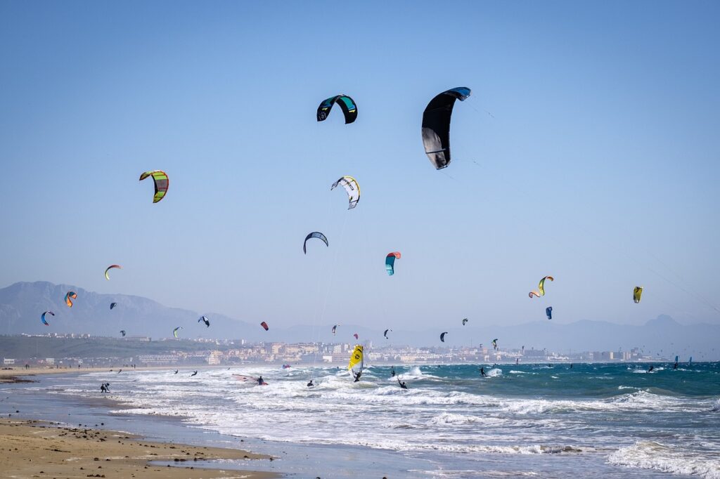 kiters, kite, beach with a lot of kitesurfers on the water