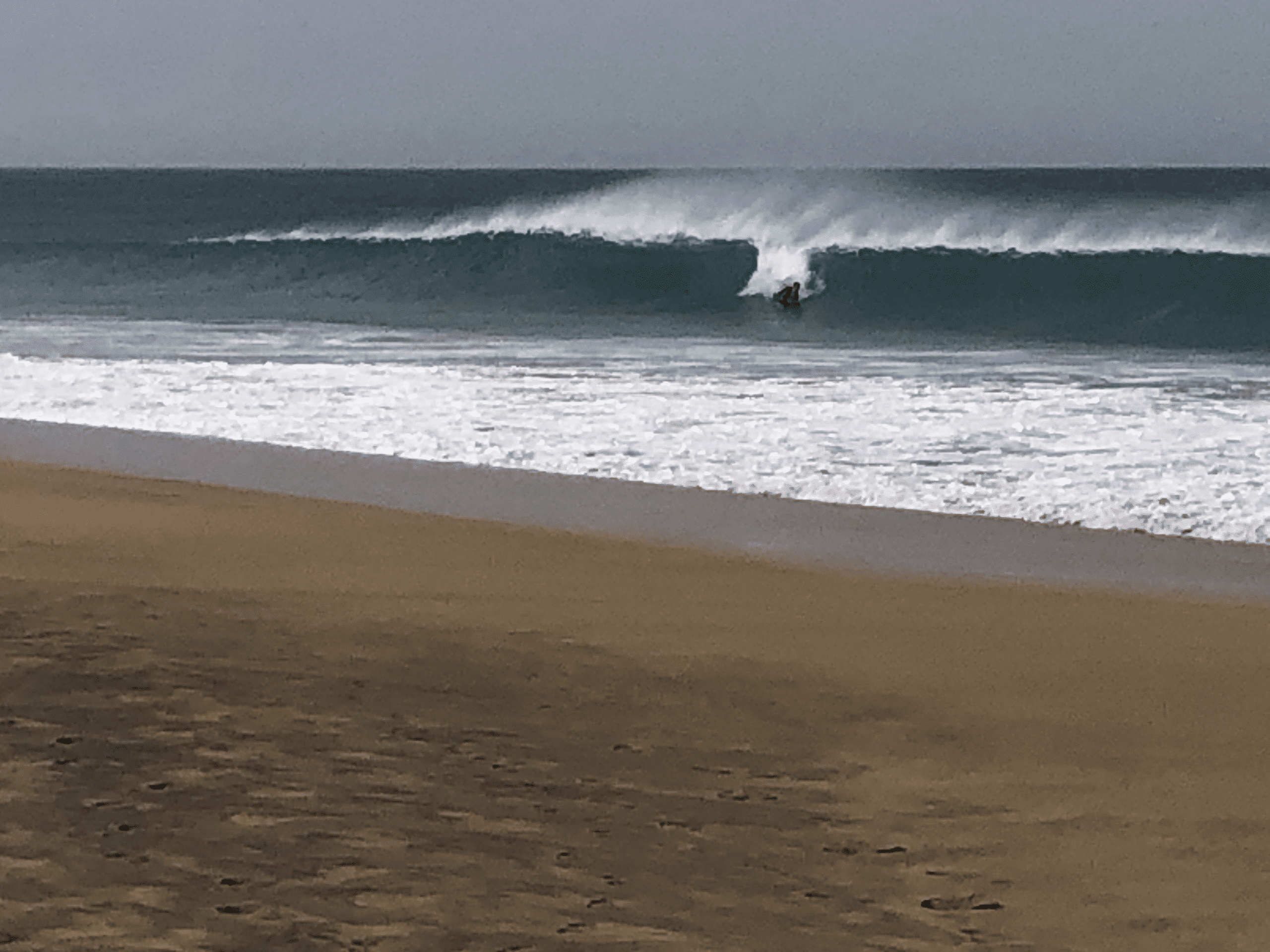 Bodyboarder or Boogie Boarder riding a wave from an article answering the question how big do waves need to be to Boogie Board