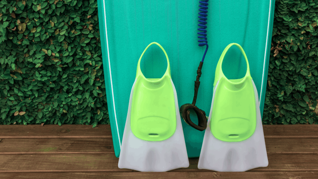 Green and grey fins put up against a blue bodyboard