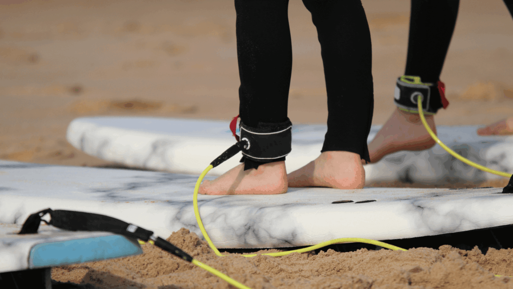 A close up of a leash attached to a person on a white bodyboard