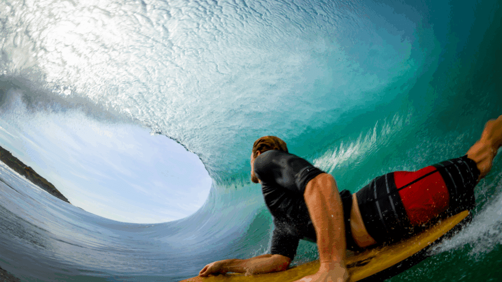 A man inside of a wave bodyboarding