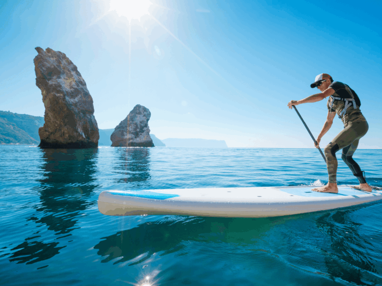 A young man paddling on his electric paddle board