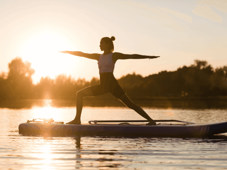 A woman doing yoga on her stand up paddle board